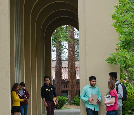 Students relax under tall arches