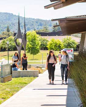 Students walking on a beautiful green campus